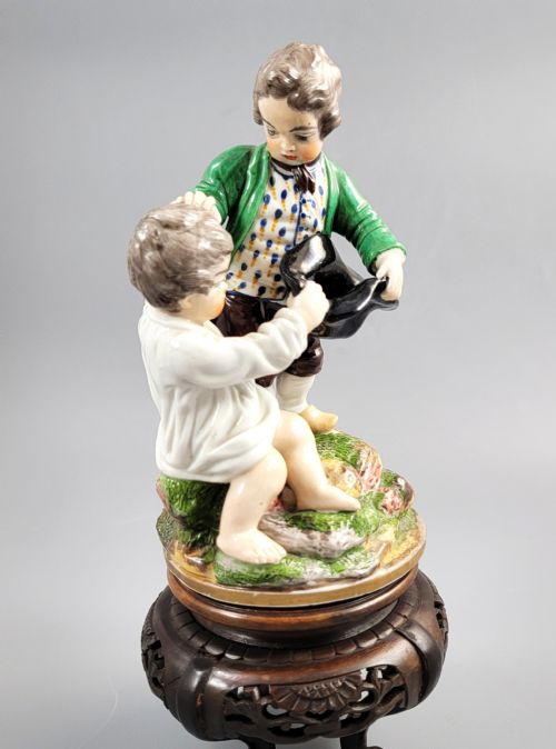 fig 1. A French Niderviller porcelain figure group depicting two young boys on a rocky naturalistic base.