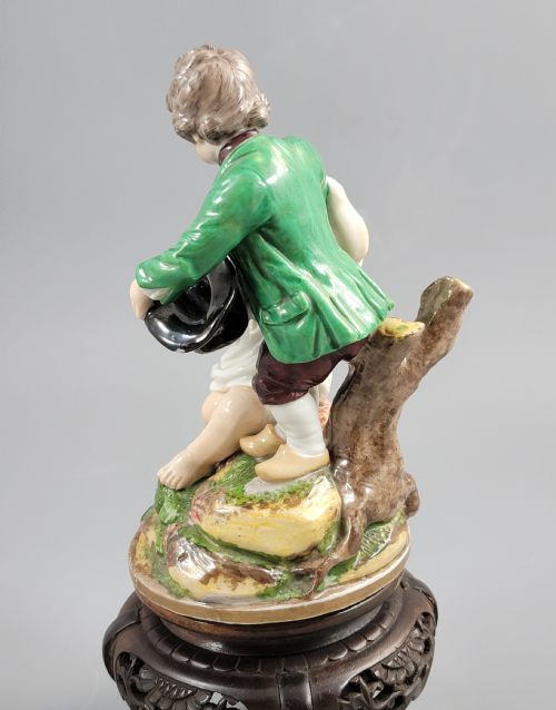 fig 2. A French Niderviller porcelain figure group depicting two young boys on a rocky naturalistic base.