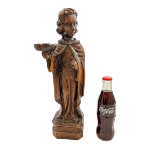 fig 3. An 18th-century Continental carved wooden figure of an acolyte in draped robes holding a small dish, mounted on a square plinth.