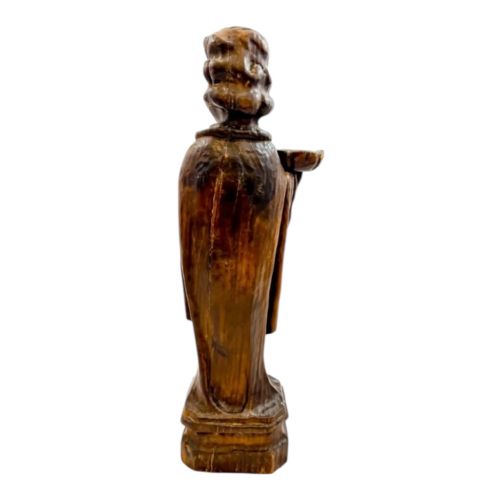 fig 4. An 18th-century Continental carved wooden figure of an acolyte in draped robes holding a small dish, mounted on a square plinth.