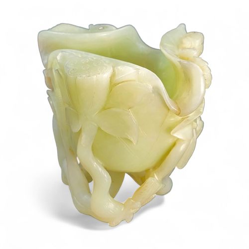 fig 2. A pale celadon green jade cup sculpted into the form of a lotus leaf with surrounding stems and buds.