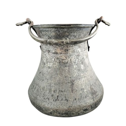 fig 2. An 18th-century Persian engraved bronze ritual vessel featuring repeating boteh patterns, a flared upper rim, and a curved metal swing handle.