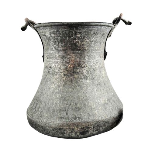 fig 3. An 18th-century Persian engraved bronze ritual vessel featuring repeating boteh patterns, a flared upper rim, and a curved metal swing handle.