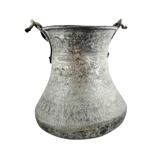 fig 4. An 18th-century Persian engraved bronze ritual vessel featuring repeating boteh patterns, a flared upper rim, and a curved metal swing handle.
