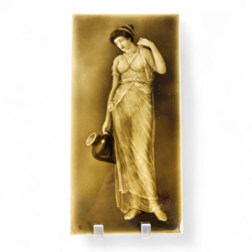 fig 1. A rectangular Victorian ceramic tile featuring a sepia-toned relief portrait of a classically draped woman holding a water ewer.