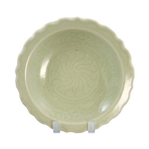 fig 3. A light celadon green ceramic dish with a scalloped foliate rim and incised floral motifs carved into the interior surface.