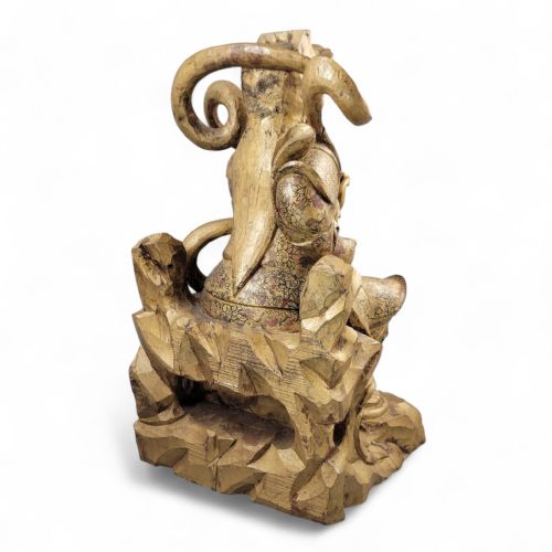 fig 3. A 19th-century carved wooden Chinese temple guardian figure with intricate gilded and polychrome surface detail seated on a carved rocky base.