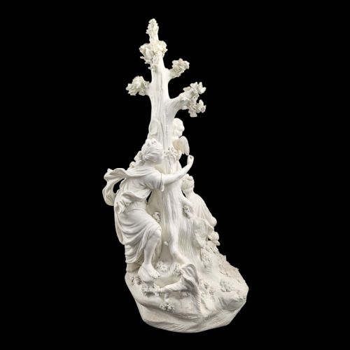 fig 3. An 18th-century white unglazed biscuit porcelain figure group depicting the Three Graces surrounding Cupid tied to a central tree trunk.