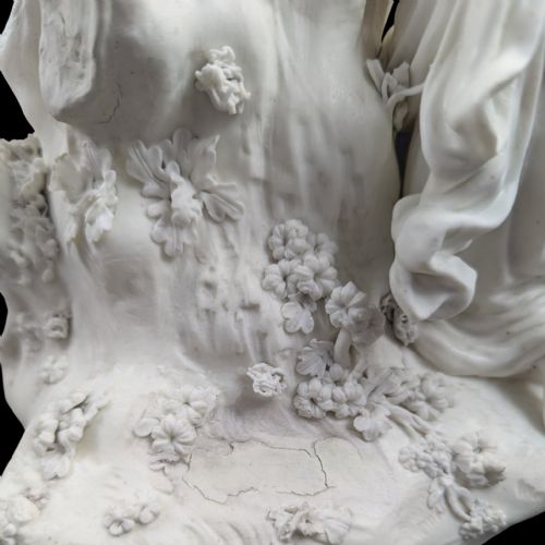 fig 4. An 18th-century white unglazed biscuit porcelain figure group depicting the Three Graces surrounding Cupid tied to a central tree trunk.