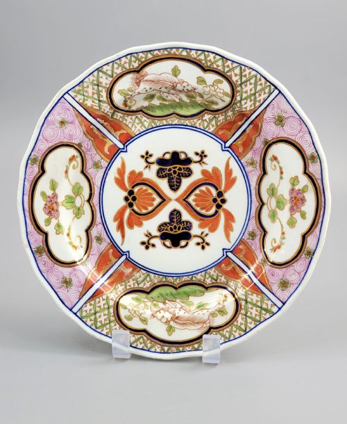 fig 1. A pair of circular late 18th-century Derby porcelain plates featuring scalloped rims and hand-painted polychrome Kylin pattern designs in orange, cobalt blue, pink, and green.