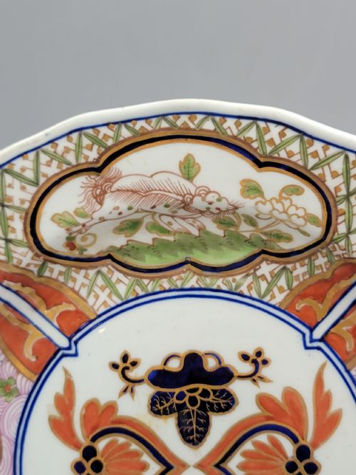 fig 2. A pair of circular late 18th-century Derby porcelain plates featuring scalloped rims and hand-painted polychrome Kylin pattern designs in orange, cobalt blue, pink, and green.