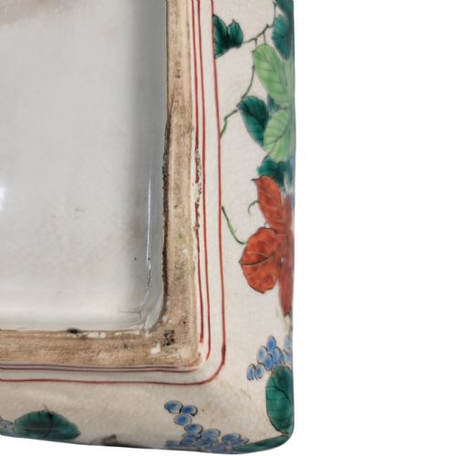 fig 3. A rectangular Japanese Kutani porcelain platter decorated with polychrome peony blossoms and green leaves over a textured gold background, framed by a floral border.