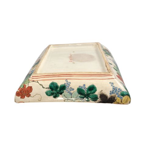 fig 5. A rectangular Japanese Kutani porcelain platter decorated with polychrome peony blossoms and green leaves over a textured gold background, framed by a floral border.
