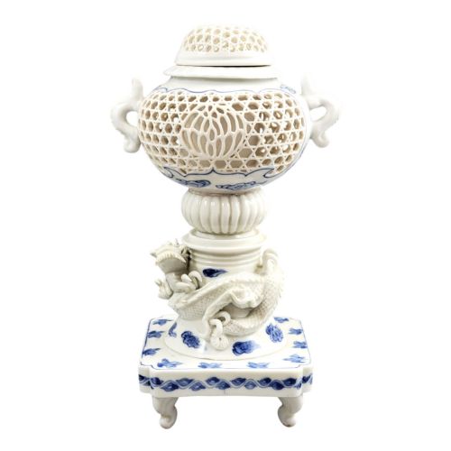 fig 1. A white and blue Japanese Hirado porcelain incense burner featuring a reticulated upper chamber, a sculpted dragon stem, and a square base.