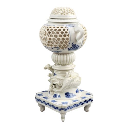 fig 3. A white and blue Japanese Hirado porcelain incense burner featuring a reticulated upper chamber, a sculpted dragon stem, and a square base.