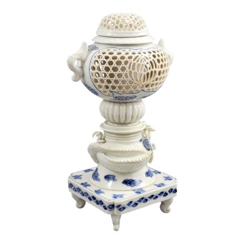 fig 4. A white and blue Japanese Hirado porcelain incense burner featuring a reticulated upper chamber, a sculpted dragon stem, and a square base.