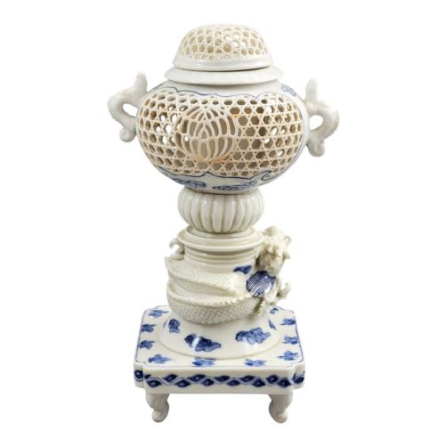fig 5. A white and blue Japanese Hirado porcelain incense burner featuring a reticulated upper chamber, a sculpted dragon stem, and a square base.