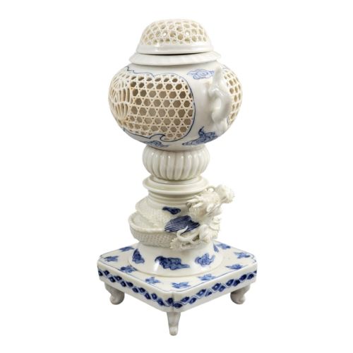 fig 6. A white and blue Japanese Hirado porcelain incense burner featuring a reticulated upper chamber, a sculpted dragon stem, and a square base.