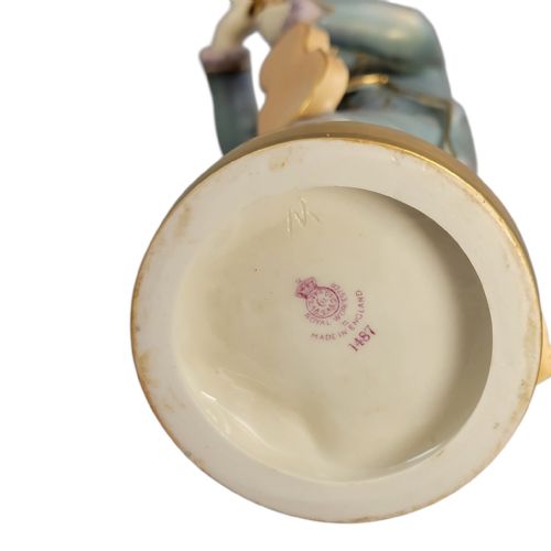 fig 2. A Royal Worcester porcelain figurine depicting a young Mozart in 18th-century attire tuning a violin atop a gilded circular base.