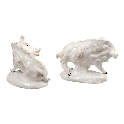 fig 3. A pair of 18th-century off-white porcelain figures depicting wild boars with painted bristle details set on low naturalistic bases with small floral motifs.