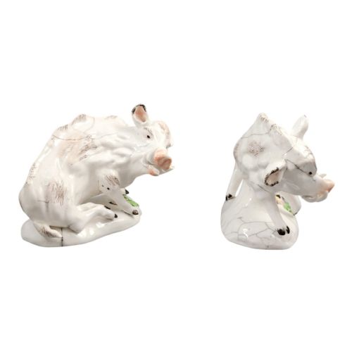 fig 4. A pair of 18th-century off-white porcelain figures depicting wild boars with painted bristle details set on low naturalistic bases with small floral motifs.