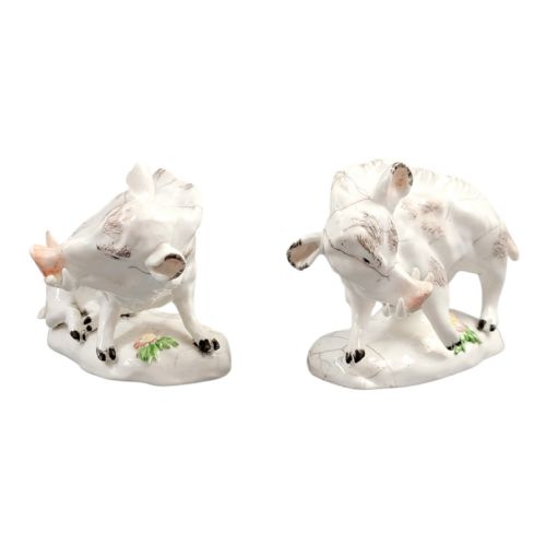 fig 5. A pair of 18th-century off-white porcelain figures depicting wild boars with painted bristle details set on low naturalistic bases with small floral motifs.