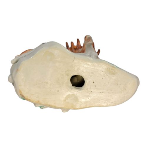 fig 4. A pair of 18th-century Derby porcelain figures depicting a reclining stag with branched antlers and a doe, painted with chestnut-spotted coats on floral-adorned white bases.
