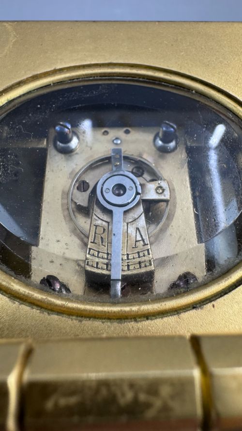 fig 5. A late 19th-century French brass carriage clock housed inside a protective, textured brown leather travelling case with a leather carrying strap.