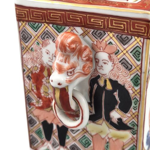 fig 5. A rectangular Japanese porcelain incense burner featuring hand-painted depictions of a European ship, decorative red enamel borders, animal head handles, and a shishi lion finial on the lid.