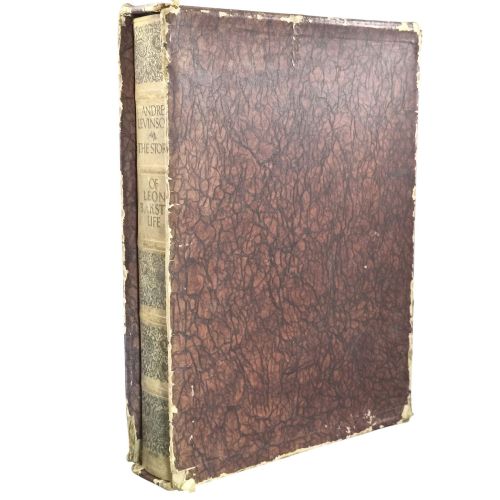 fig 1. The spine of an antique hardcover book featuring intricate gilt floral patterns and lettered text reading The Story of Leon Baksts Life by Andre Levinson.