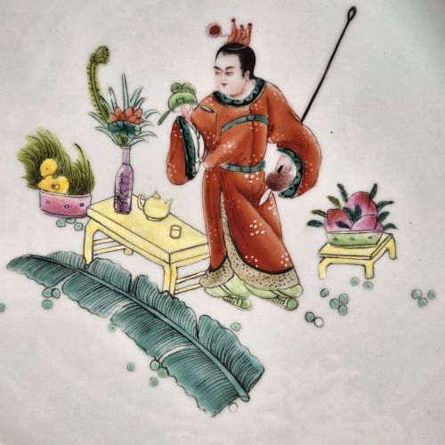 fig 2. A late Qing dynasty Chinese Famille Rose porcelain dish featuring a hand-painted central figure, lotus blossoms, butterflies, and a distinct red castellated rim.