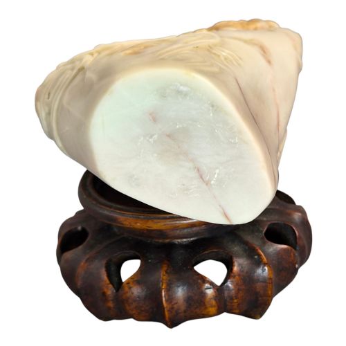 fig 2. A carved cream and tan Shoushan stone sculpture depicting a dragon amongst clouds set upon a dark turned wooden base.
