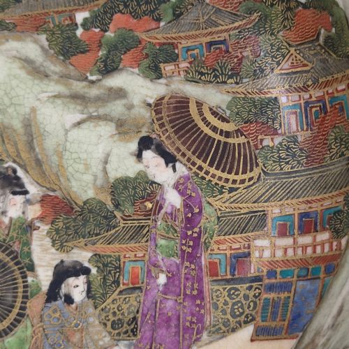fig 1. An antique cream earthenware bowl resting on a carved wooden base, decorated inside with hand-painted Japanese landscapes and figures, and finished with a bamboo pattern around the exterior.