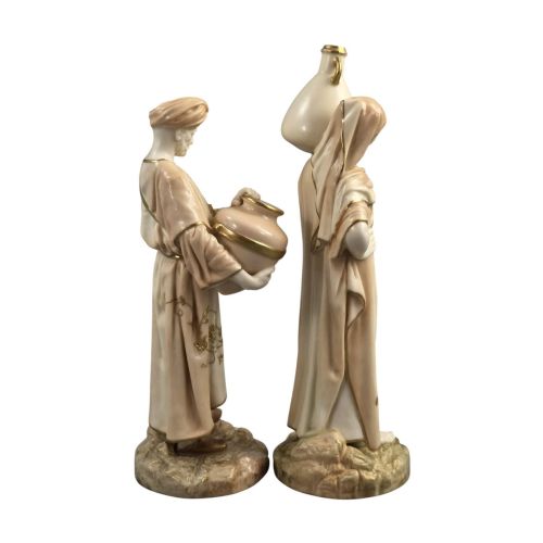 fig 3. A pair of Royal Worcester blush ivory porcelain figures depicting a male and female Cairo water carrier with gilded accents.