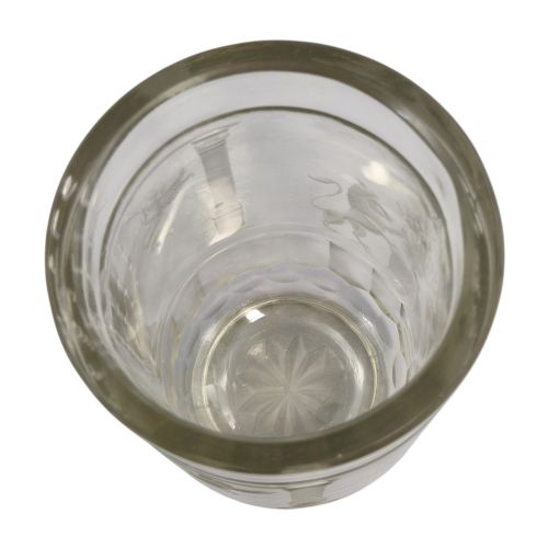 fig 10. A large clear glass beaker featuring detailed wheel-engraved ceremonial iconography, vertical fluted panels near the lower rim, and a faceted base.