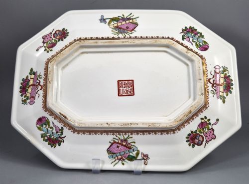 fig 1. An octagonal Chinese Famille Rose porcelain tray depicting figures in a garden court scene surrounded by floral and butterfly borders.