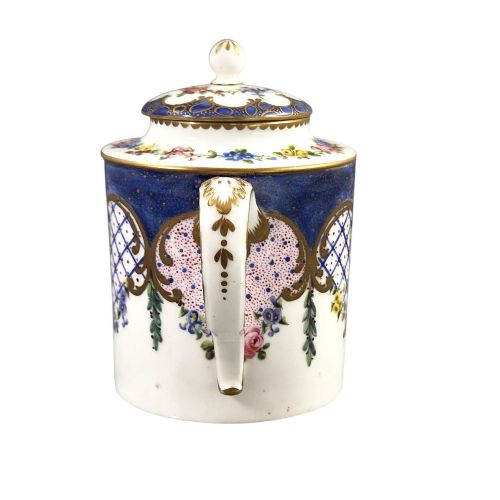 fig 1. An 18th-century French Sevres soft-paste porcelain litron teapot decorated with hand-painted floral cartouches, gilding, and cobalt blue borders.