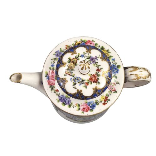 fig 4. An 18th-century French Sevres soft-paste porcelain litron teapot decorated with hand-painted floral cartouches, gilding, and cobalt blue borders.