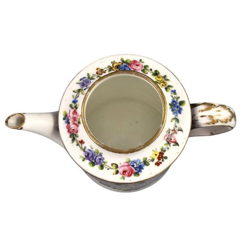 fig 5. An 18th-century French Sevres soft-paste porcelain litron teapot decorated with hand-painted floral cartouches, gilding, and cobalt blue borders.