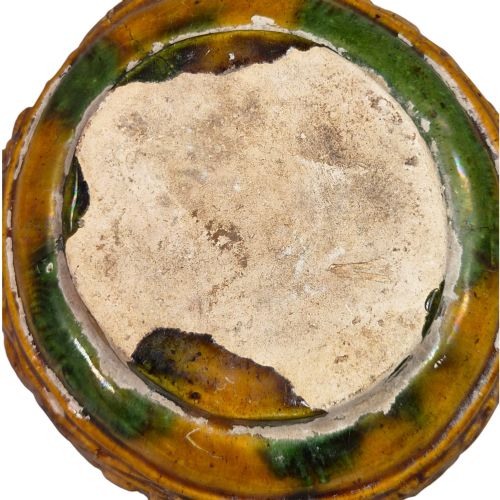 fig 6. A squat antique Chinese ceramic water vessel featuring a green glazed upper shoulder, a square rim, and an amber-glazed moulded floral band around the middle.