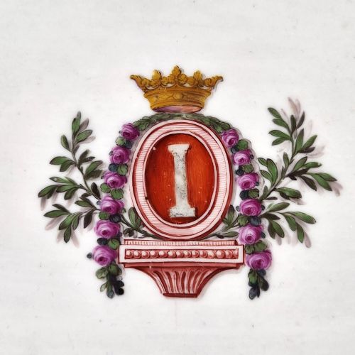 fig 3. An eighteenth-century rectangular white porcelain serving tray featuring shaped corners, delicate gilded scrollwork borders, and a central hand-painted crowned monogram.