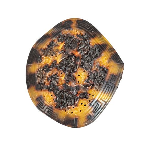 fig 5. A late 19th-century Chinese Qing Dynasty ruyi sceptre carved from translucent mottled amber and dark brown tortoiseshell with intricate relief carving along the handle and head.