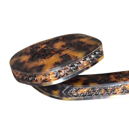 fig 7. A late 19th-century Chinese Qing Dynasty ruyi sceptre carved from translucent mottled amber and dark brown tortoiseshell with intricate relief carving along the handle and head.