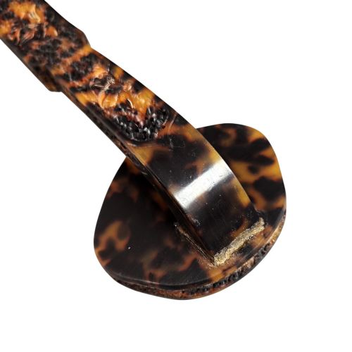 fig 8. A late 19th-century Chinese Qing Dynasty ruyi sceptre carved from translucent mottled amber and dark brown tortoiseshell with intricate relief carving along the handle and head.