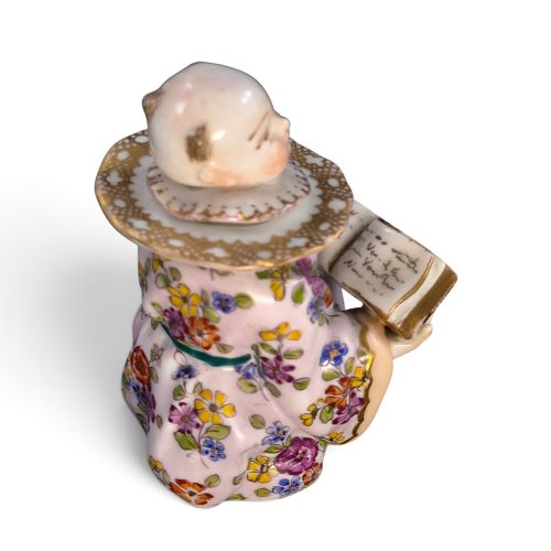 fig 4. A pair of antique French Samson porcelain figural inkwells depicting singing boys wearing floral robes and gilt-rimmed ruffs while holding open songbooks.