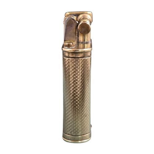 fig 1. A 1920s Dunhill Unique gold-plated petrol lighter featuring an engine-turned pattern and a straight-arm lift mechanism.