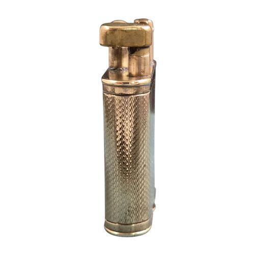 fig 3. A 1920s Dunhill Unique gold-plated petrol lighter featuring an engine-turned pattern and a straight-arm lift mechanism.