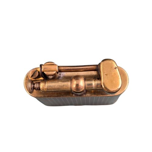fig 5. A 1920s Dunhill Unique gold-plated petrol lighter featuring an engine-turned pattern and a straight-arm lift mechanism.
