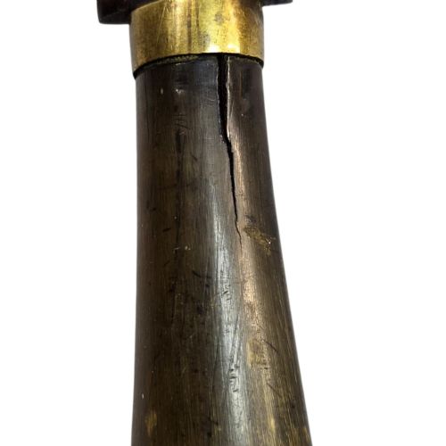 fig 5. A 19th-century Pesh-Kabz knife featuring a recurved single-edged steel blade with surface etching, a brass bolster, and a tapered carved horn handle.