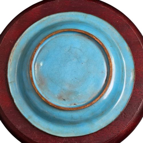 fig 9. An eighteenth-century Chinese Canton enamel wine cup with green dragon-shaped handles resting on a matching round saucer, decorated with floral motifs and symbols.